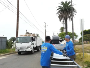 Eclipse Metal Roofing crew feeding a standing seam panel off an on-site roll former